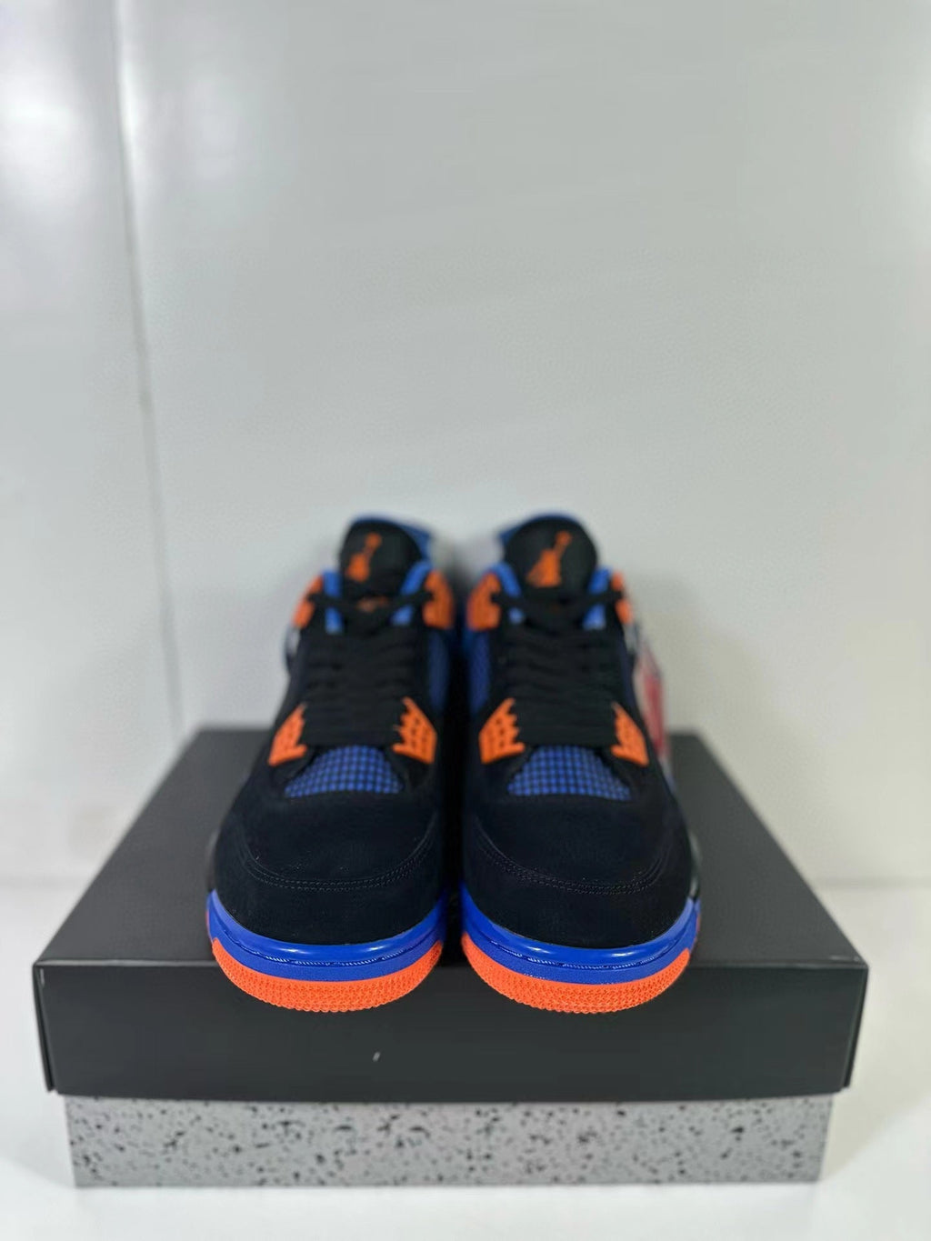 Air Jordan 4 Retro Black Blue Orange Sneakers - product image from the listing.