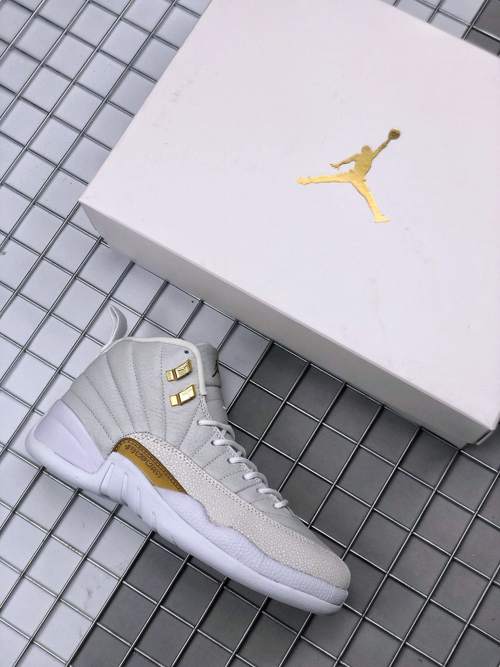 Air Jordan 12 OVO Sneakers in White Gold 873864-102 - product image from the listing.