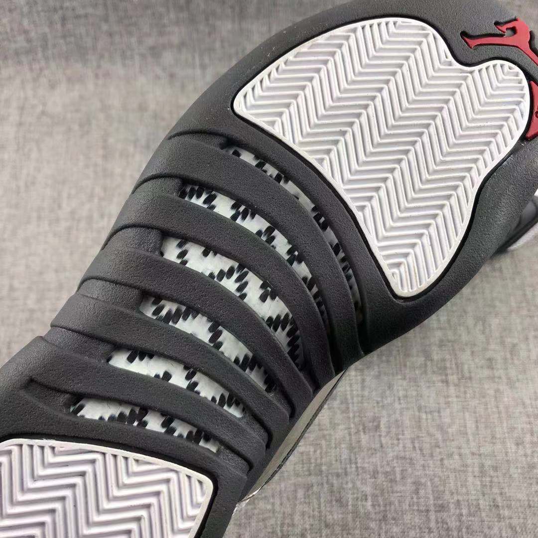 Air Jordan 12 Retro Taxi White Black Sneakers - product image from the listing.