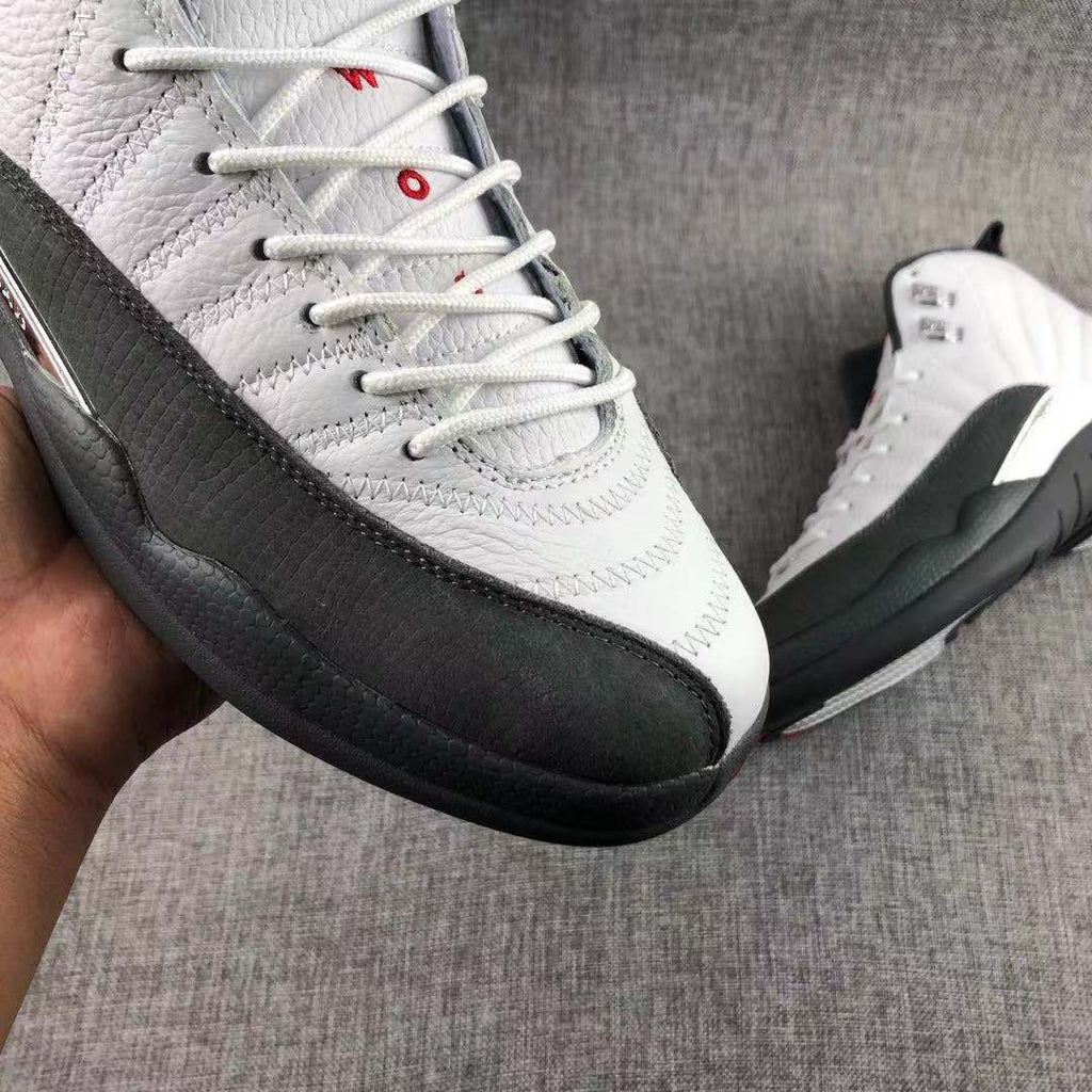 Air Jordan 12 Retro Taxi White Black Sneakers - product image from the listing.