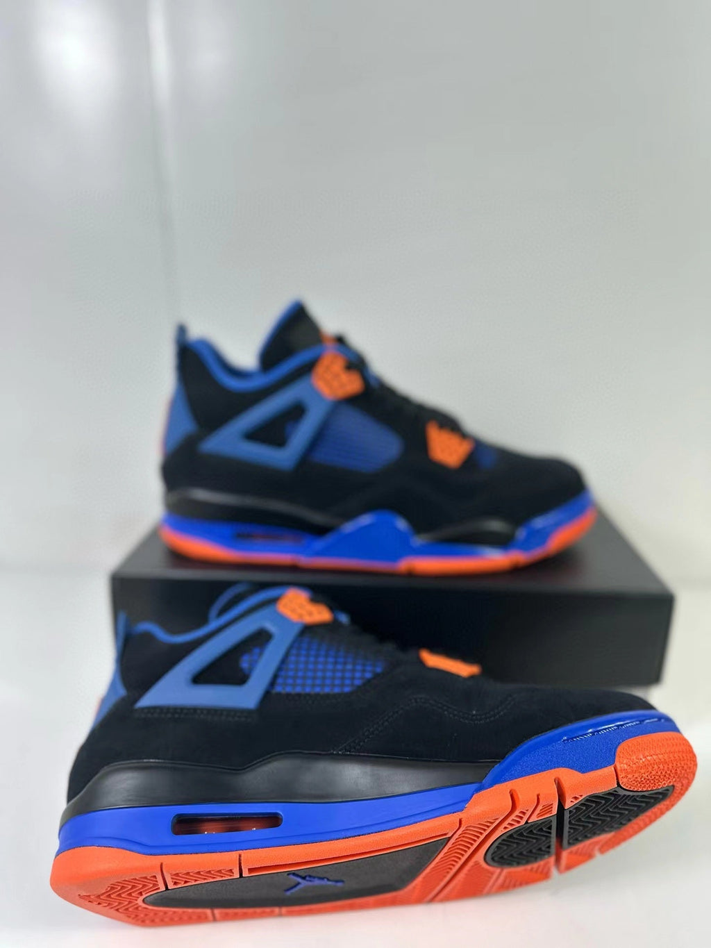 Air Jordan 4 Retro Black Blue Orange Sneakers - product image from the listing.