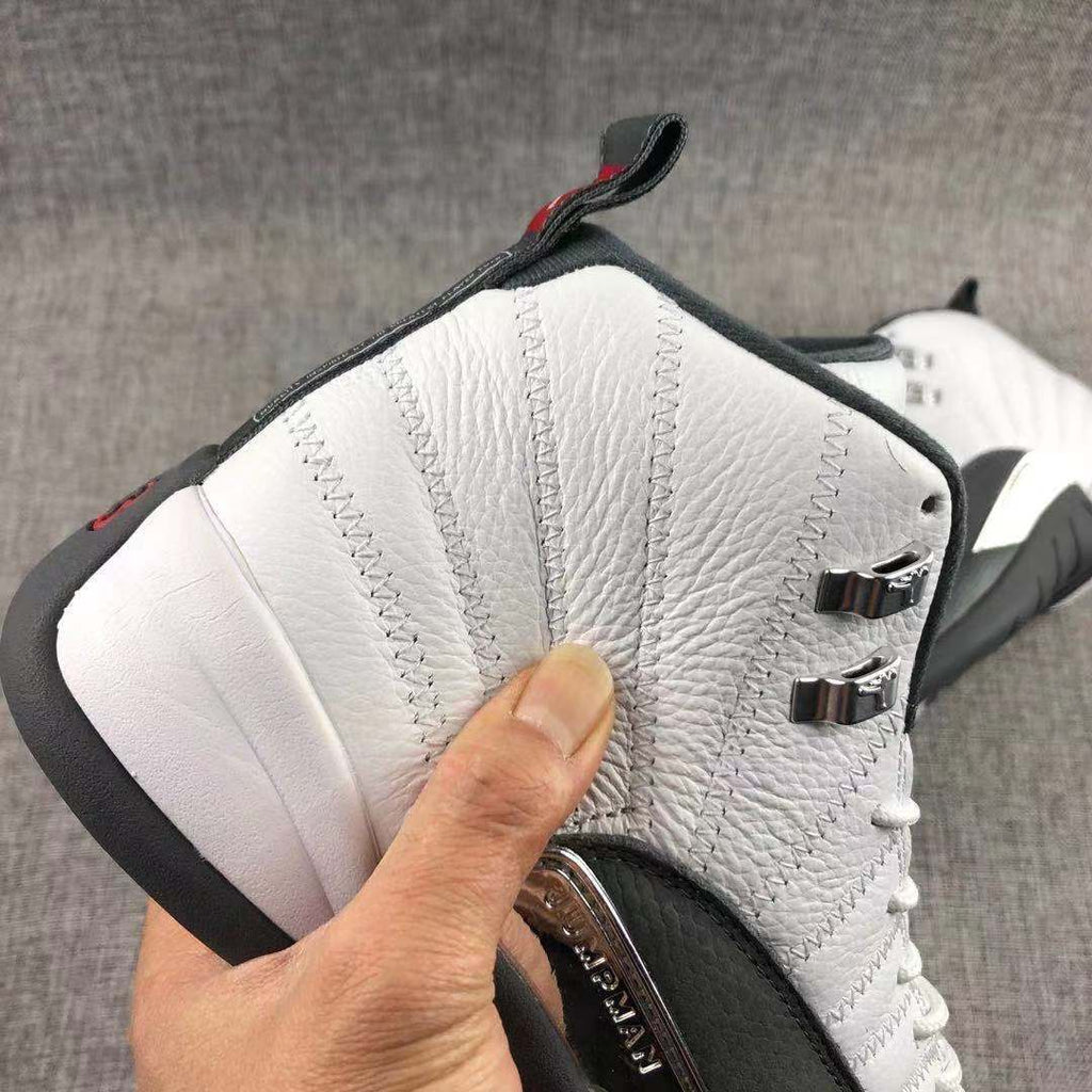 Air Jordan 12 Retro Taxi White Black Sneakers - product image from the listing.